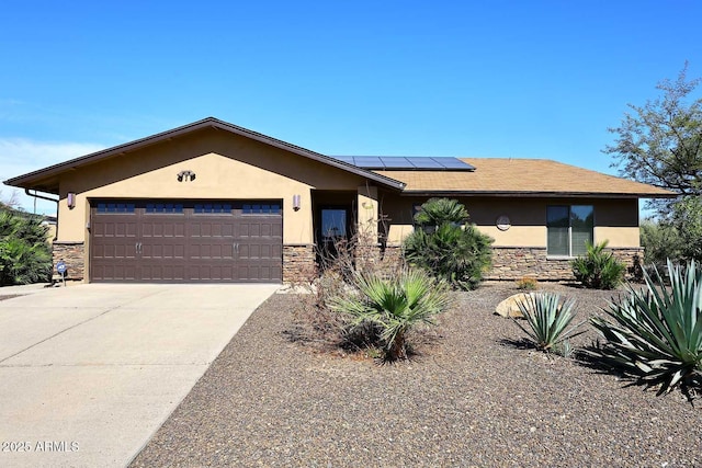 view of front of property featuring stone siding, stucco siding, concrete driveway, and a garage