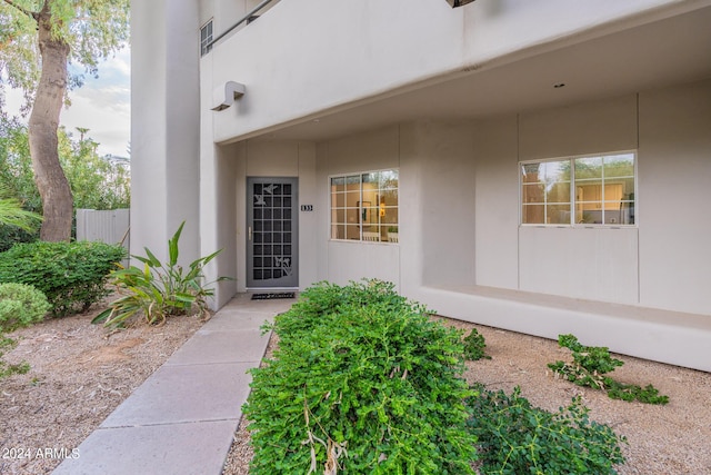 entrance to property featuring stucco siding