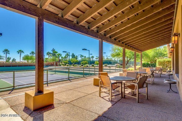 view of patio featuring a tennis court