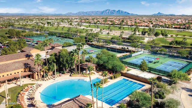 birds eye view of property with view of golf course and a mountain view