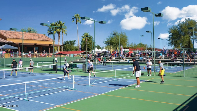 view of tennis court featuring fence