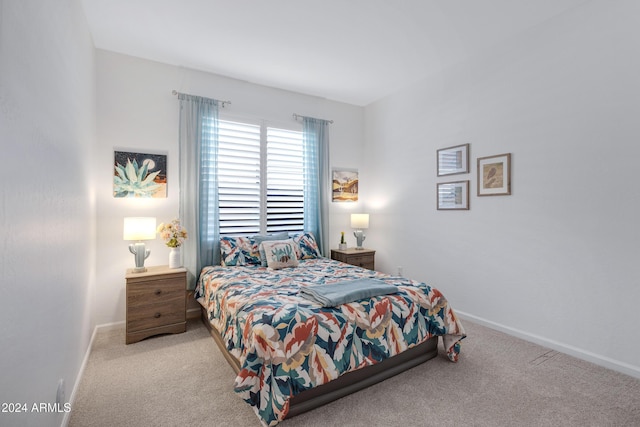 bedroom featuring carpet and baseboards