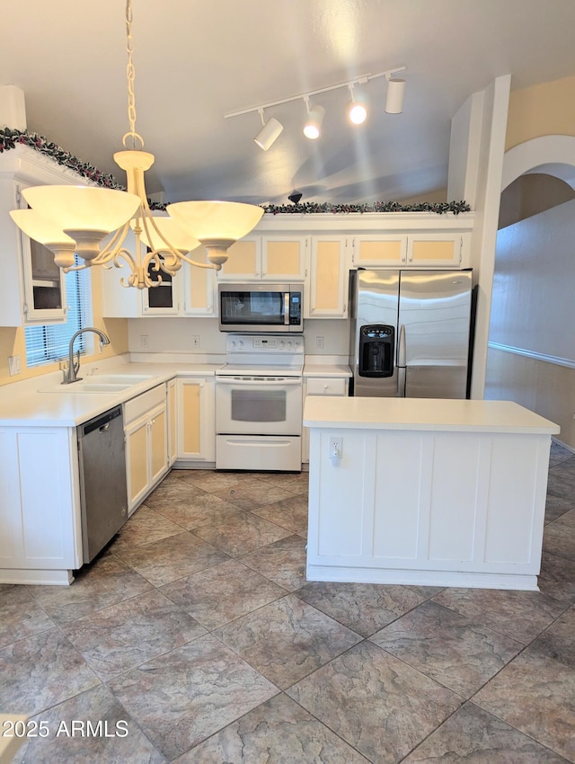 kitchen with light countertops, a chandelier, appliances with stainless steel finishes, and a sink