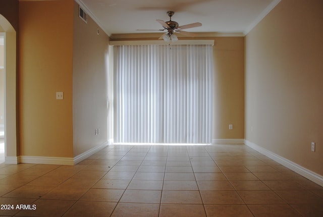 unfurnished room featuring ornamental molding, light tile patterned flooring, and ceiling fan