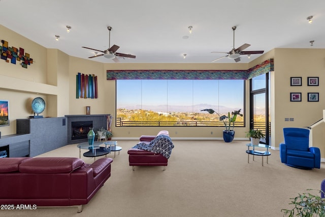 carpeted living room with a mountain view and ceiling fan