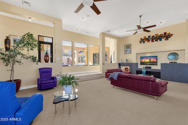 living room with ceiling fan and carpet