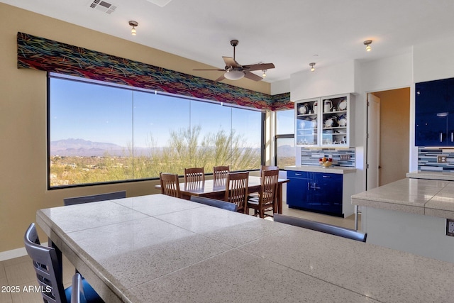 dining space featuring a mountain view and ceiling fan