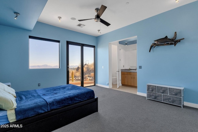 bedroom featuring connected bathroom, access to exterior, ceiling fan, and light carpet