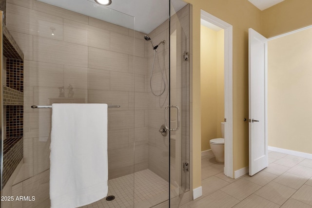 bathroom with an enclosed shower, tile patterned flooring, and toilet