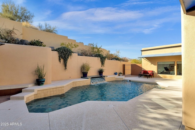 view of pool featuring pool water feature and a patio