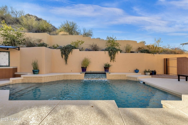 view of pool featuring pool water feature and a patio area