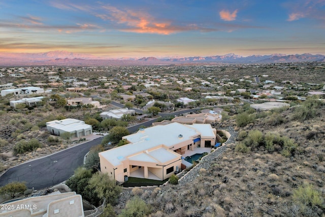 aerial view at dusk featuring a mountain view