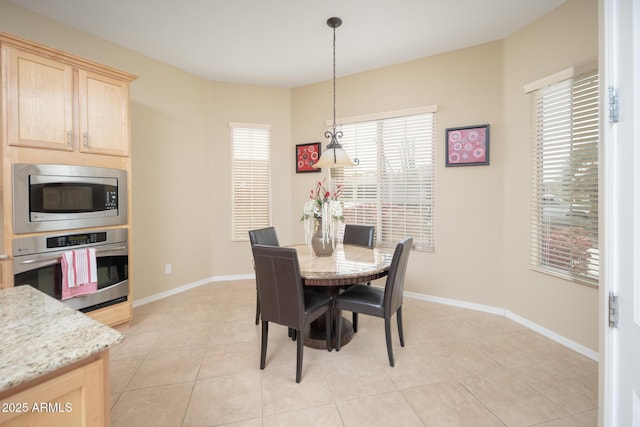 dining space featuring light tile patterned floors