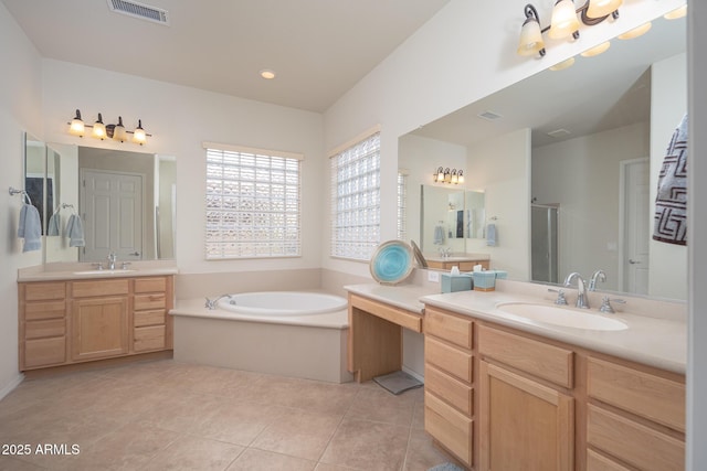 bathroom with tile patterned floors, shower with separate bathtub, and vanity