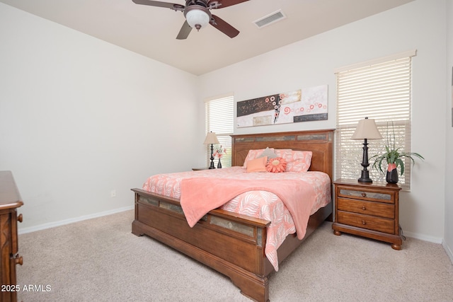 bedroom featuring light colored carpet and ceiling fan