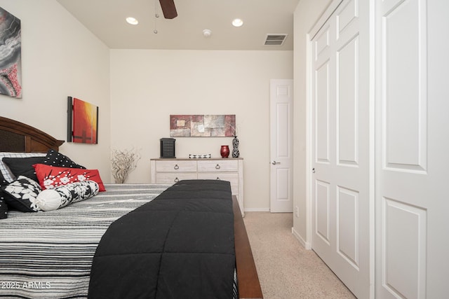 carpeted bedroom with a closet and ceiling fan