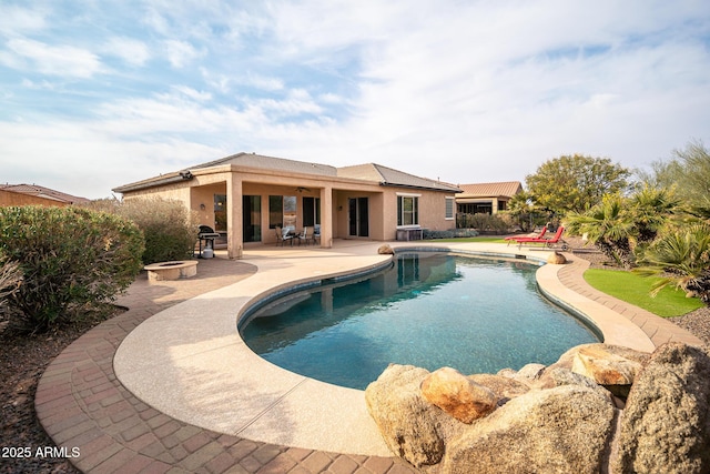 view of swimming pool with a patio area and an outdoor fire pit