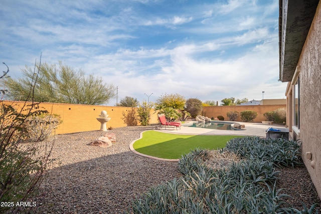 view of yard featuring a fenced in pool and a patio area