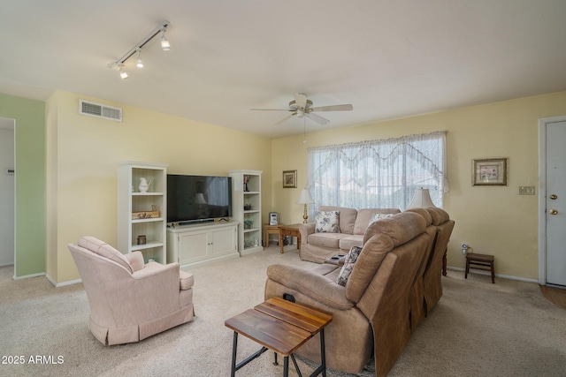 living room with ceiling fan, track lighting, and light colored carpet