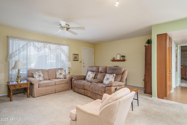 living room with light colored carpet and ceiling fan