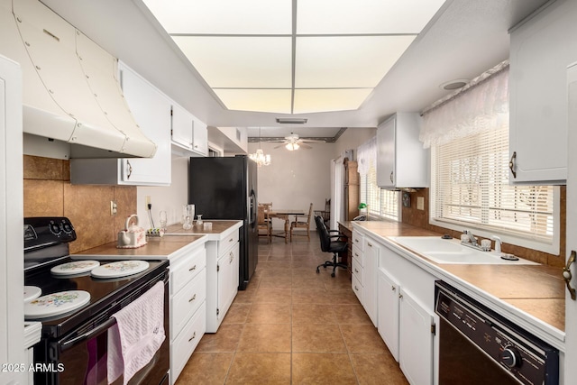 11109 W Granada Dr, Sun City, AZ 85373 - kitchen featuring light tile patterned floors, a sink, tasteful backsplash, and black appliances