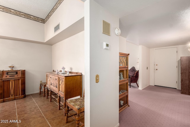 11109 W Granada Dr, Sun City, AZ 85373 - hall featuring tile patterned floors, carpet, baseboards, and visible vents
