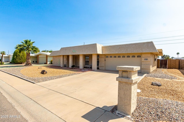 11109 W Granada Dr, Sun City, AZ 85373 - view of front of property featuring concrete driveway, stucco siding, fence, and an attached garage