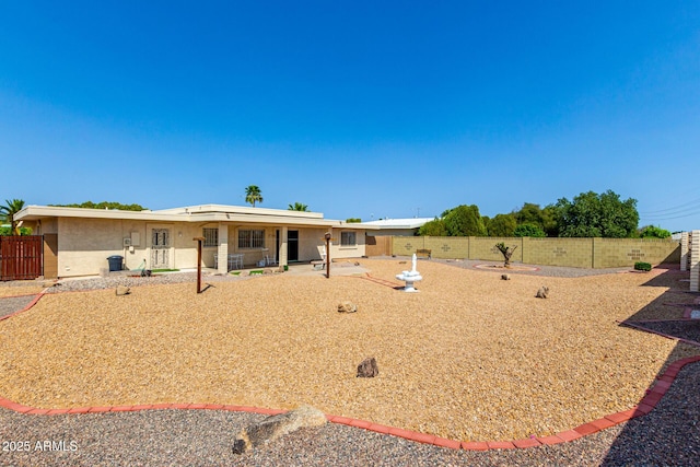11109 W Granada Dr, Sun City, AZ 85373 - view of front of home with a fenced backyard, stucco siding, and a patio area