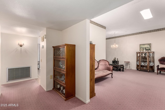 11109 W Granada Dr, Sun City, AZ 85373 - living area with carpet, baseboards, a chandelier, and visible vents