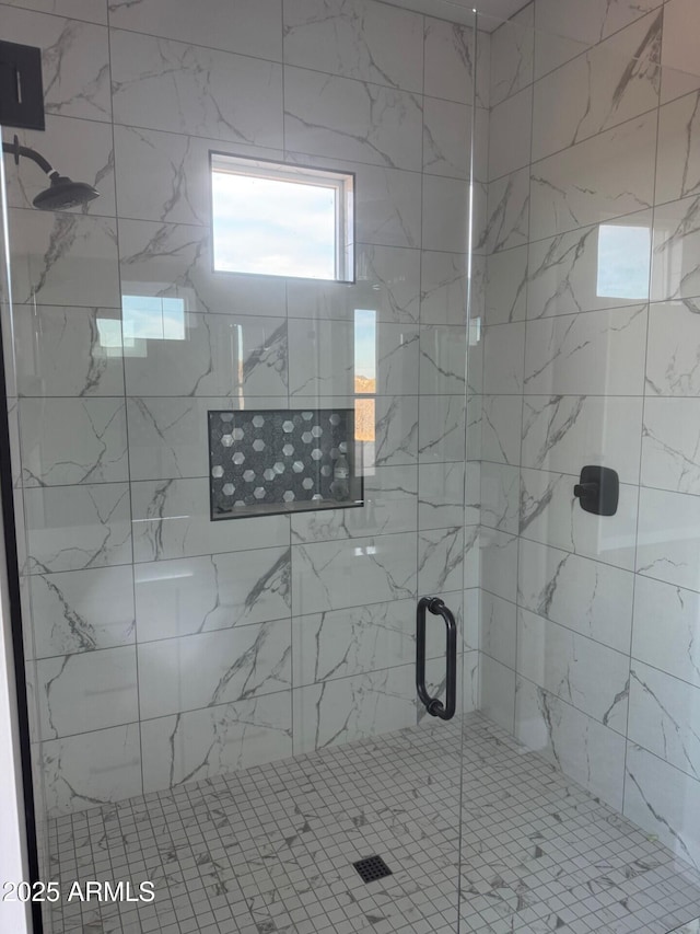 bathroom featuring a shower with door