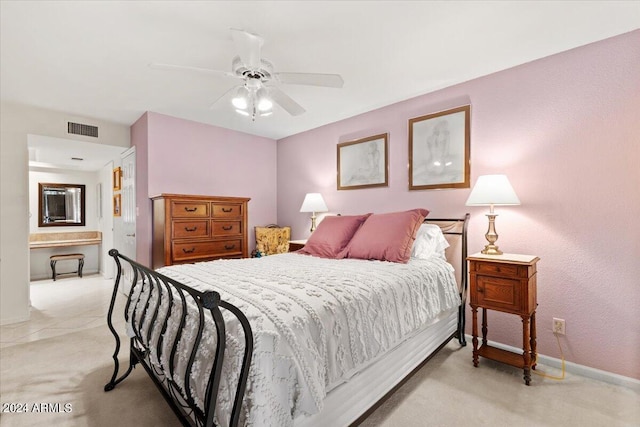 bedroom with ceiling fan and light carpet