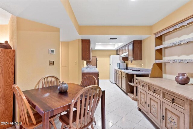 tiled dining area featuring sink