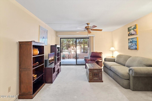 living room with ceiling fan and light colored carpet