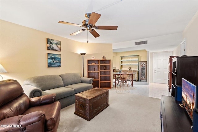 tiled living room with ceiling fan