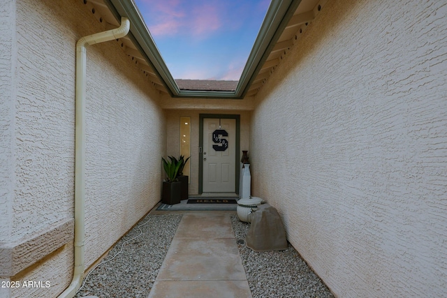 entrance to property with stucco siding