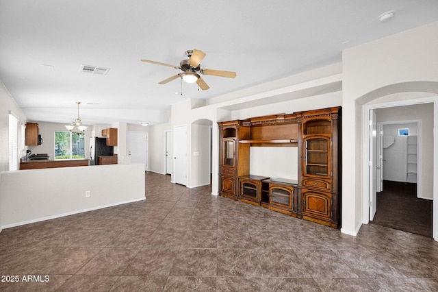 unfurnished living room featuring arched walkways, baseboards, visible vents, and ceiling fan with notable chandelier