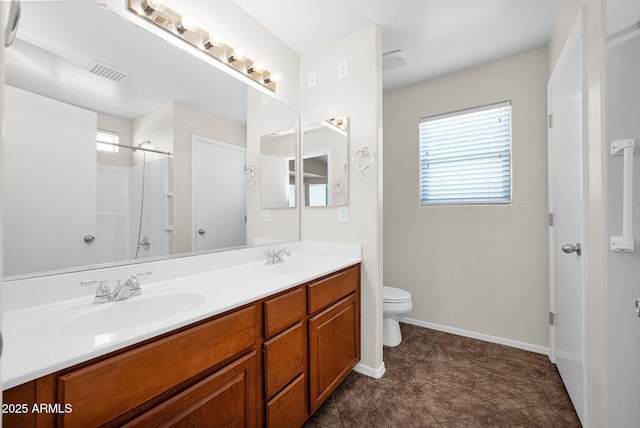 full bath with a sink, toilet, a shower, and visible vents