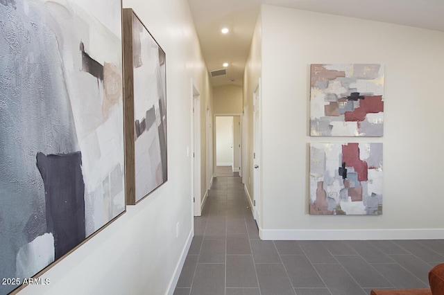 hall featuring dark tile patterned floors