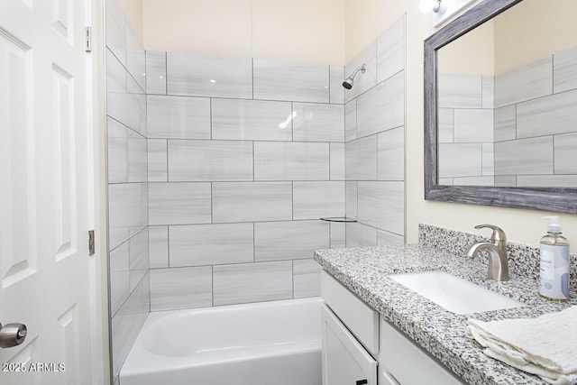 bathroom featuring vanity and tiled shower / bath combo