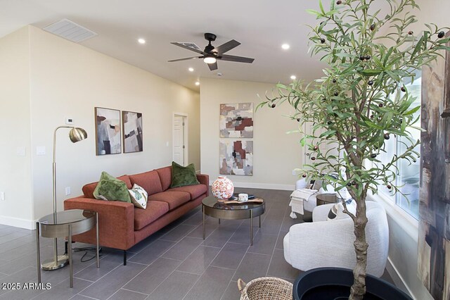 living room featuring ceiling fan and dark tile patterned floors