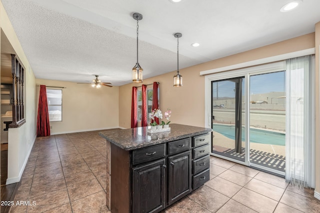 4114 E Muirwood Dr, Phoenix, AZ 85048 - kitchen featuring pendant lighting, a kitchen island, ceiling fan, recessed lighting, and dark cabinets