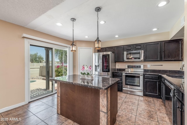 4114 E Muirwood Dr, Phoenix, AZ 85048 - kitchen with appliances with stainless steel finishes, a sink, a center island, dark stone counters, and recessed lighting