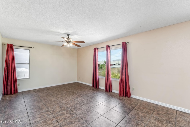 4114 E Muirwood Dr, Phoenix, AZ 85048 - tiled spare room featuring ceiling fan, a textured ceiling, and baseboards