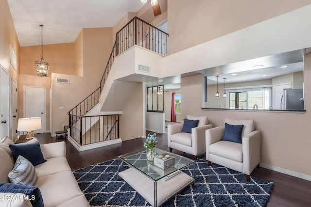 4114 E Muirwood Dr, Phoenix, AZ 85048 - living area with wood finished floors, a high ceiling, plenty of natural light, stairway, and baseboards