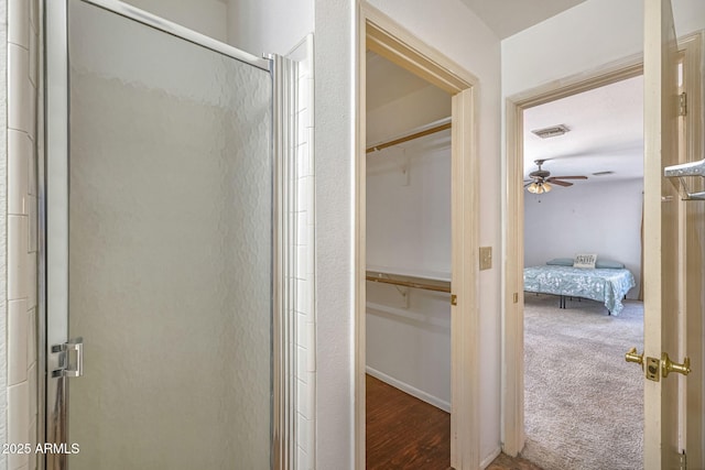 4114 E Muirwood Dr, Phoenix, AZ 85048 - bathroom with a shower stall, ensuite bath, a walk in closet, and a ceiling fan