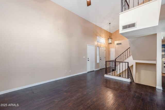 4114 E Muirwood Dr, Phoenix, AZ 85048 - unfurnished living room featuring high vaulted ceiling, wood finished floors, baseboards, and stairway