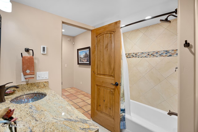 bathroom with tile patterned flooring, sink, and shower / bath combination with curtain