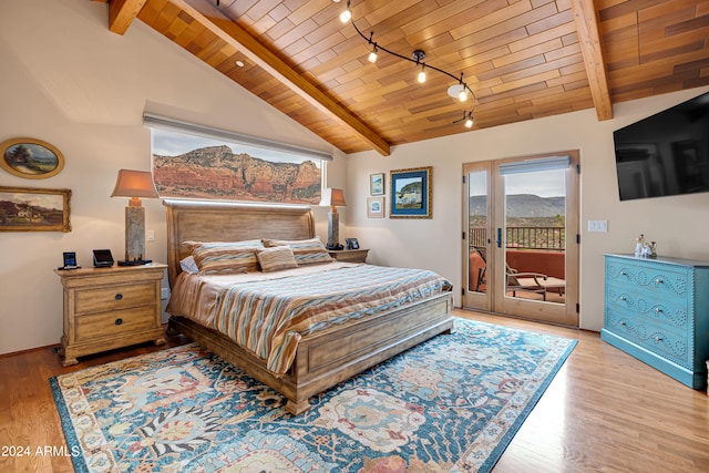 bedroom featuring rail lighting, vaulted ceiling with beams, wood ceiling, light hardwood / wood-style flooring, and access to outside