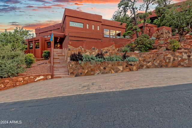 view of outdoor building at dusk