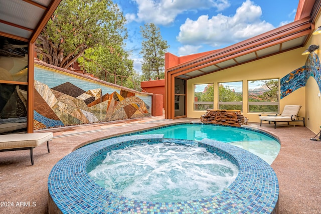 view of swimming pool with an in ground hot tub